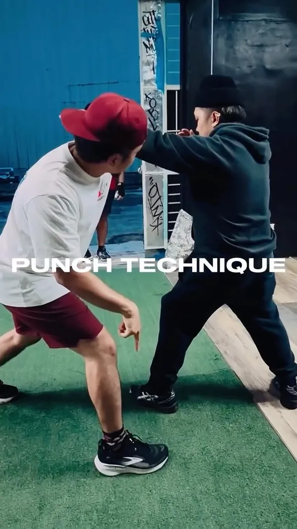 Coach Ren working one-on-one on punch technique